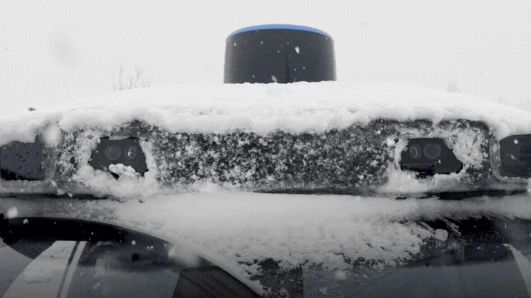 The 6th-Generation Waymo Driver's central perception dome in the snow.